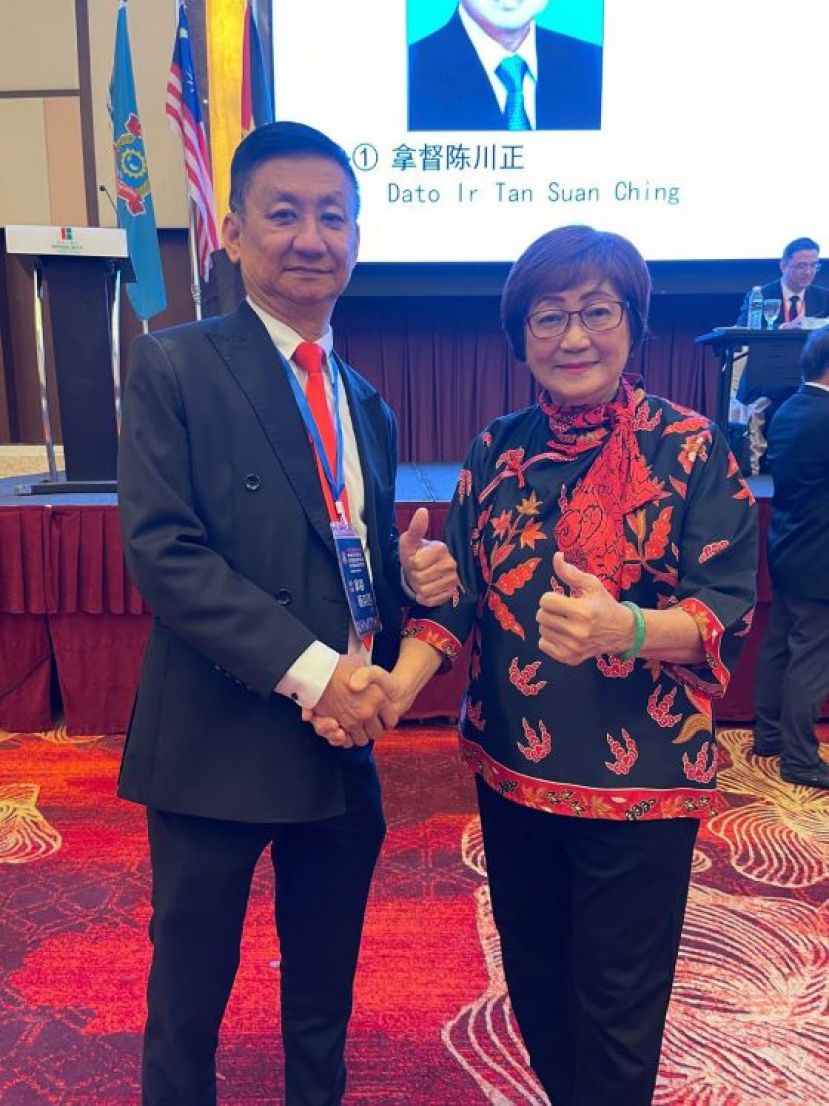马来西亚海南会馆联合会前任总会长拿督林秋雅（右）祝贺新任总会长杨克浩时影。