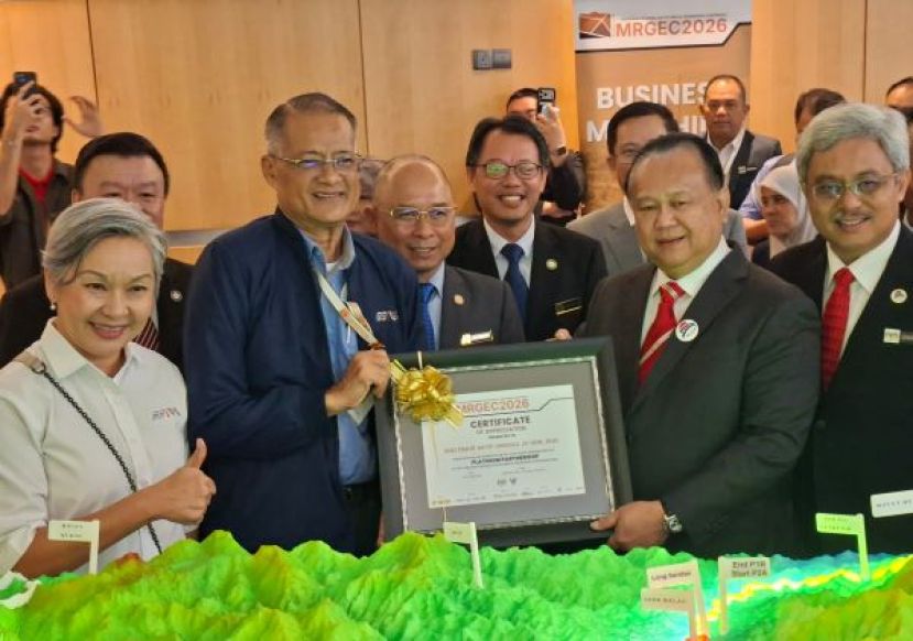 工程部长拿督斯里亚历山大南达林奇今日在古晋为首届马来西亚区域岩土工程大会上巡视参展摊位时移交感谢奖予负责人时影。