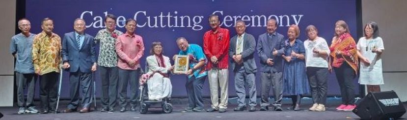 在众嘉宾的陪同下，喜乐双福关怀协创办人沈秋香（左六）赠送纪念品予南市市长拿督黄鸿圣时影。