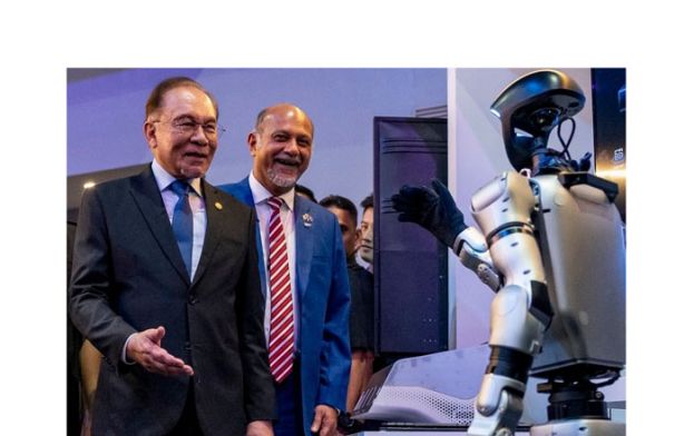 首相安华（左）参观人工智慧机器人展览，右为数码部长哥宾星。