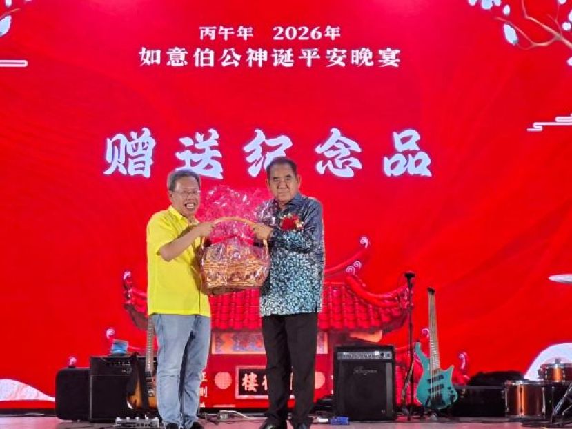 十哩如意伯公神诞值年炉主兼筹委会主席天猛公刘石星（右）赠送纪念品予主宾拿督阿玛沈桂贤时摄。