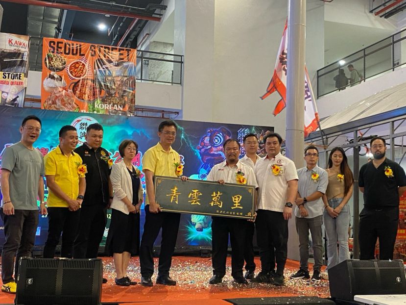 筹委会主席杨子然（右6）在嘉宾们的陪同下，赠送纪念品予巴达旺市议会主席陈开（左5）。