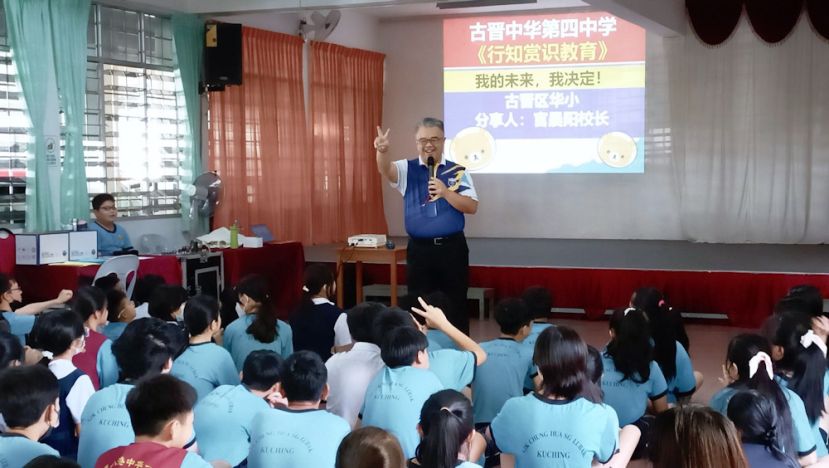 古晋四中校长官晨阳在五哩八港路中华公学与六年级学生分享“2025年四中升学资讯”。