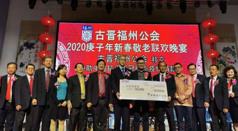 古晋福州公会会长拿督余志豪（右五）移交10万人民币作为抗击新冠肺炎疫情之用，由中国驻古晋副总领事张阳接收（左七）。