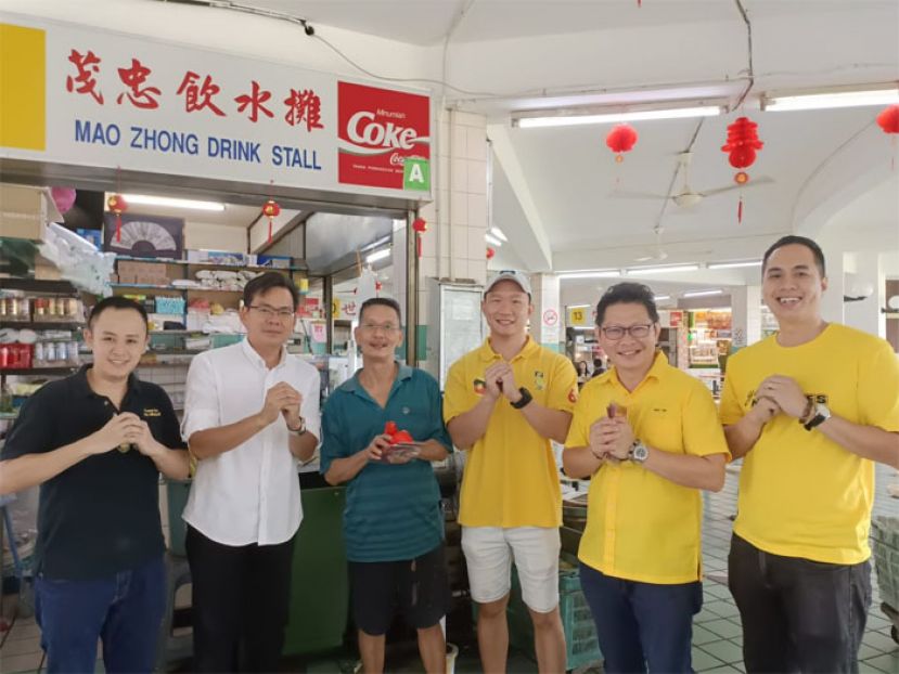 甲必丹郭贵华（左二）、青年团长郑志国 （右二）、青年团秘书符顺顺 （右三），青年团培训副秘书沈东耀 （右一），青年团委员杨英福（左一）发年柑予商家。